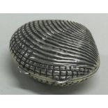 A silver box in the form of a shell. Marked to interior.