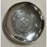 WANG HING: A Chinese silver dish with Chinese emperor coin to centre.