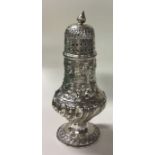A large chased silver sugar caster. London 1897. By Josiah Williams & Co.