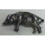 A silver figure of a pig.