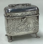 A silver chased tea caddy bearing import marks.