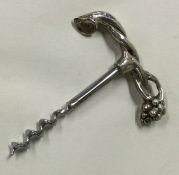 A silver tree and grape vine corkscrew.