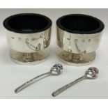 GERALD BENNEY: A good heavy pair of circular silver salts with crested decoration.