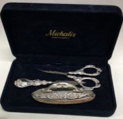 A chased silver manicure set.