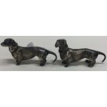 A pair of silver figures of dachshunds bearing import marks.