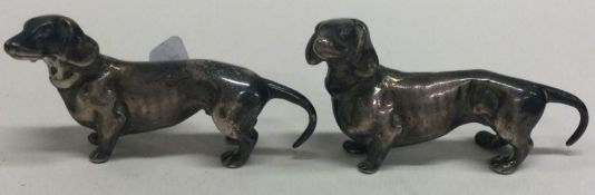 A pair of silver figures of dachshunds bearing import marks.