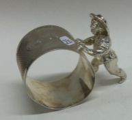 A rare novelty silver figural napkin ring. London 2000. By TCP.