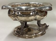 A good English import marked silver bowl cast with dolphins.