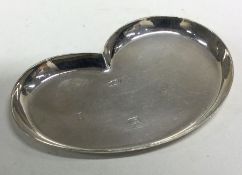 A E JONES: A good stylish silver pin dish of shaped form.