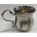 A chased silver christening mug. Sheffield 1910. By RF Mosley & Co.