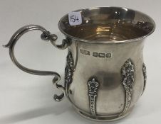A chased silver christening mug. Sheffield 1910. By RF Mosley & Co.