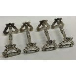 A fine set of four George III silver knife rests.