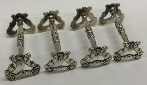 A fine set of four George III silver knife rests.