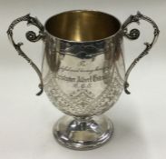 A Vctorian silver two handled cup with engraved decoration. London 1876. By H J Lias & Son.