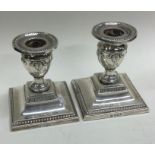 A pair of Victorian silver candlesticks with beaded border square. Sheffield 1905.