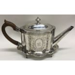 A good Georgian silver teapot on stand engraved with flowers and foliage. London 1788/1789.