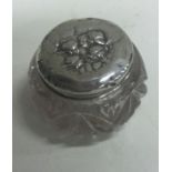 A silver mounted glass box decorated with cherubs.