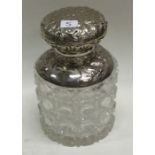 A good cut glass and silver mounted scent bottle with floral decoration.