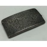 A small engraved silver card case with hinged top.