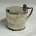 A Georgian silver lidded mustard pot. London 1820.
