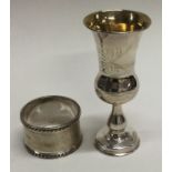 A small silver Kiddush cup together with a napkin ring.