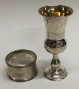 A small silver Kiddush cup together with a napkin ring.