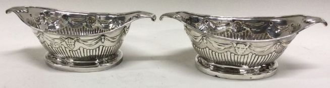 A heavy pair of Georgian style silver salts with swag decoration. London.