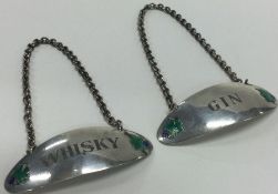 A pair of silver and enamelled wine labels for 'Gin' and 'Whisky'.
