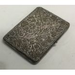 A fine quality silver card case with chased decoration.