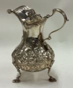 A Victorian chased silver jug embossed with flowers. London 1854.