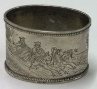 An early 20th Century Russian silver napkin ring engraved with equestrian scenes.