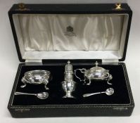 A good cased silver three piece cruet set of shaped form. Birmingham. By Mappin & Webb.