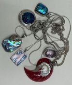 A large collection of heavy silver pendants etc.