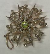 A pearl and peridot pendant/brooch with flower decoration.