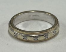 A heavy 9 carat gold diamond band ring.
