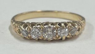 A good diamond five stone half hoop ring in 18 carat gold claw setting.