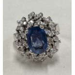 A heavy 18 carat gold sapphire and diamond modern cluster ring.