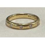 A good diamond five stone gypsy set ring in 18 carat gold.