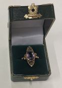 A large 14 carat gold amethyst ring with bead decoration.