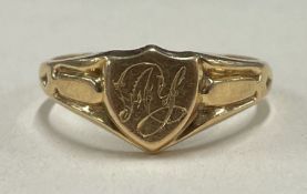 A small 18 carat gold signet ring of shield form.