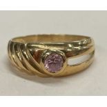 A high carat gold single stone ring with twist mount.