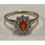 An attractive circular cluster ring in 9 carat claw mount.