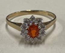 An attractive circular cluster ring in 9 carat claw mount.