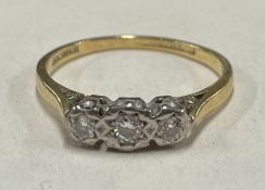 A small diamond three stone ring in 18 carat and platinum.