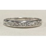 A diamond half eternity ring in 9 carat of plain form.