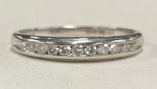 A diamond half eternity ring in 9 carat of plain form.