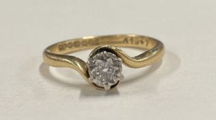 A small diamond single stone crossover ring in claw mount.