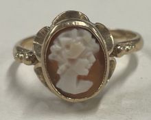 A small gold cameo ring depicting a lady's head.