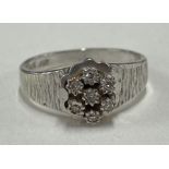 A modern 9 carat cluster ring in textured mount.