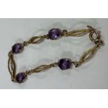 An attractive 9 carat and amethyst four stone bracelet.